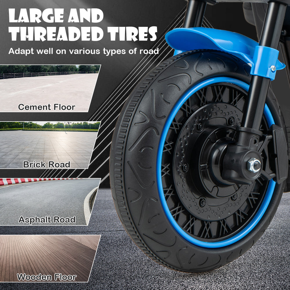 Close-up of the large, threaded tire of the blue kids electric motorcycle, suitable for various road types.