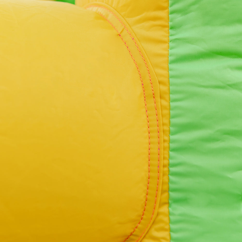 Close-up of the yellow and green waterproof oxford cloth on the kids inflatable water slide for safe summer fun.