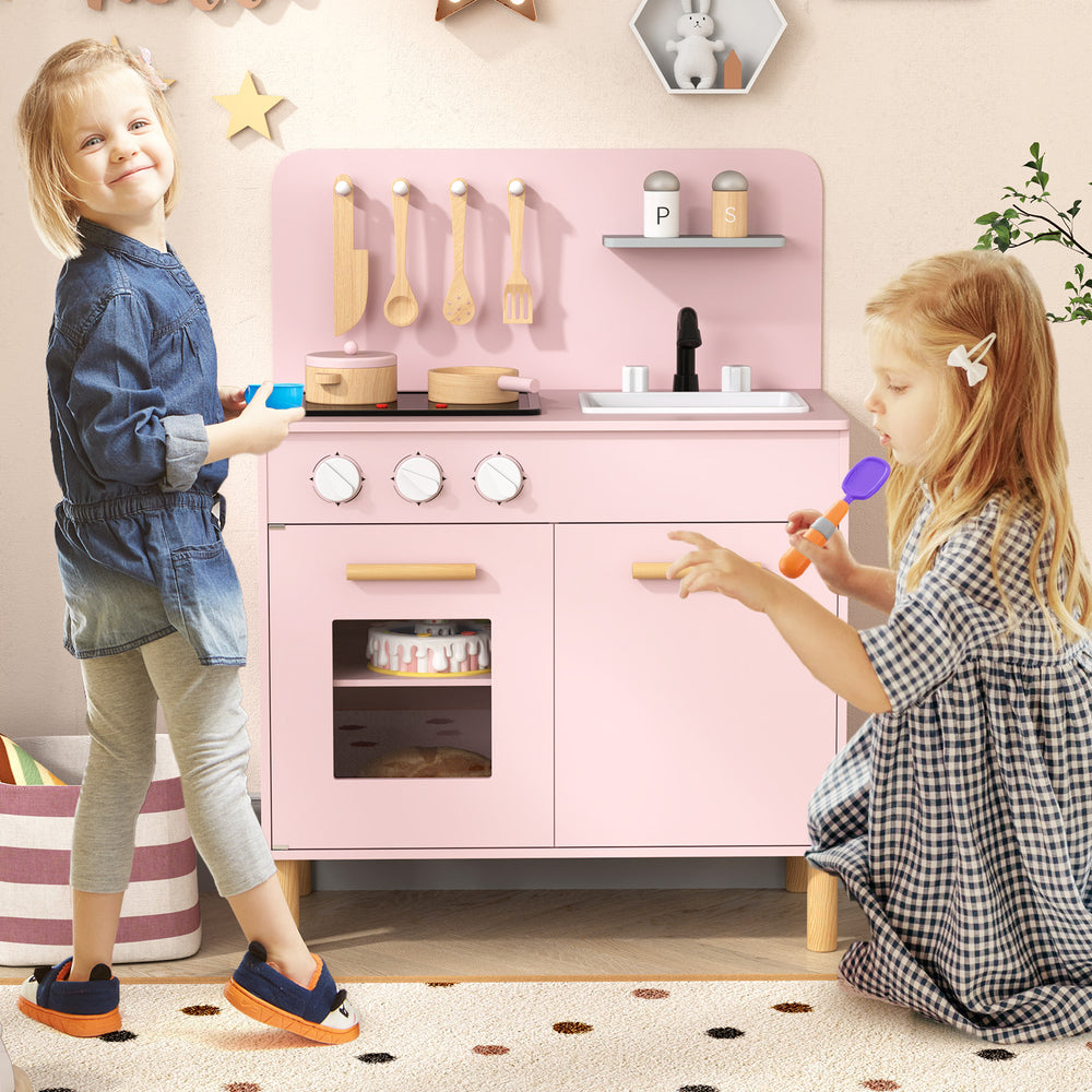 Kids kitchen playset in pink with dual stoves, cooking accessories, and storage for imaginative role-playing.