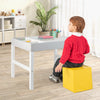 Kids sitting at the 3 in 1 Wooden Kids Table with Storage, featuring a reversible tabletop for versatile activities.
