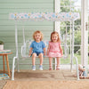 Kids patio swing with adjustable canopy, featuring a sturdy metal frame and fun patterns, perfect for outdoor play.