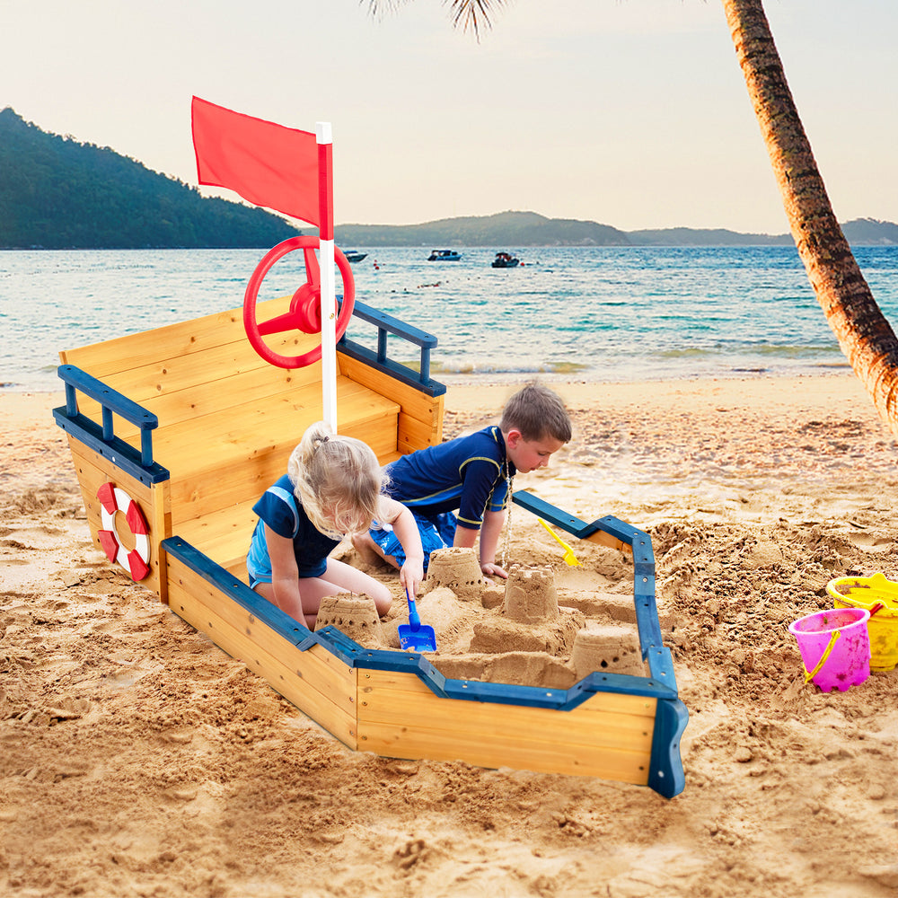 Kids playing in a wooden pirate boat sandbox with lifebuoy and rudder, perfect for outdoor fun and creativity.