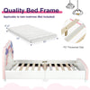 Kids twin size platform bed featuring a colorful rainbow-patterned headboard and raised side rails for mattress.