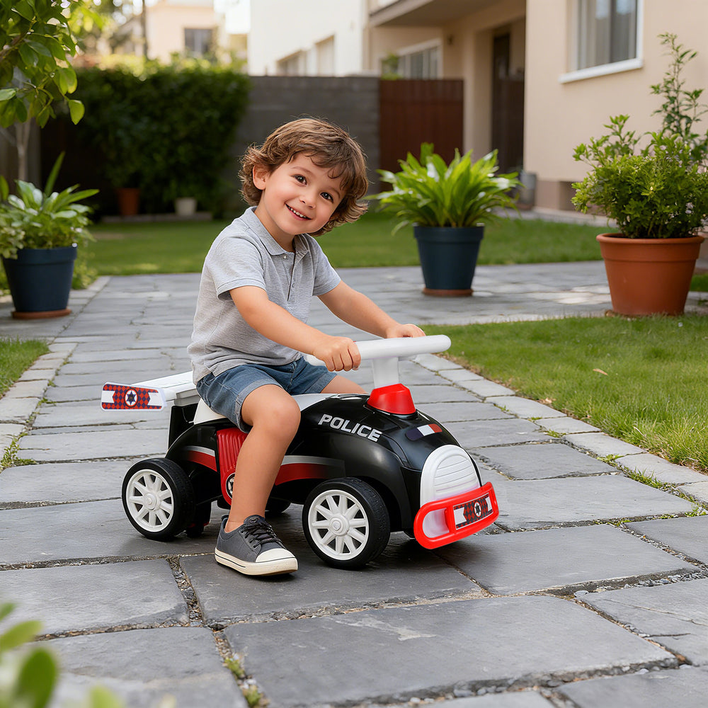 Kids ride-on car toy in black and red with music, under-seat storage, and smooth riding wheels for fun outdoor play.