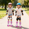 Two girls wearing adjustable kids roller skates with light-up wheels, enjoying a sunny day in the park.