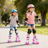 Two girls roller skating in adjustable rose red skates with light-up wheels, wearing helmets and protective gear in a.