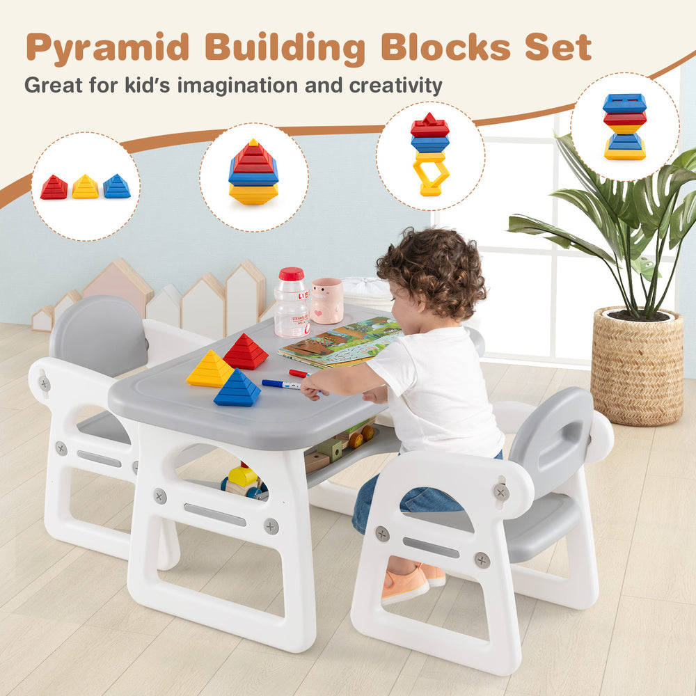 Gray kids table and chair set with building blocks, showcasing a spacious desktop with recesses for cups and toys.