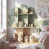Tree-shaped kids bookshelf in green with open shelves, featuring apple-shaped cutouts for playful storage and display.