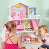 Kids playing with the pink wooden dollhouse playset featuring 5 rooms and movable furniture for imaginative fun.
