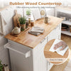 White kitchen island cart with rubber wood countertop, shown in a kitchen with towel rack and adjustable shelves.