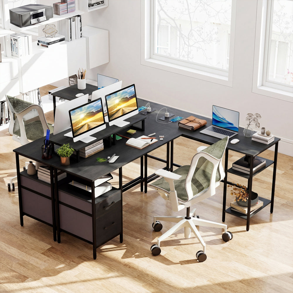 L-shaped black desk with monitor stands, open shelves, and built-in power outlet for versatile office use.