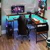 L-shaped gaming desk in rustic brown with LED lights, power outlets, and ergonomic monitor stand for versatile use.