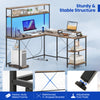 L-shaped reversible gaming desk in rustic brown with LED strip, adjustable monitor stand, and heavy-duty metal frame.