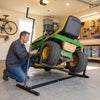 Lawn mower lift jack in use, featuring heavy-duty metal construction and adjustable height for maintenance tasks.