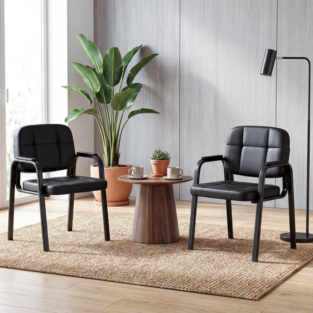 Set of 2 leather office reception chairs with cushioned seats and ergonomic backrests, perfect for waiting areas.