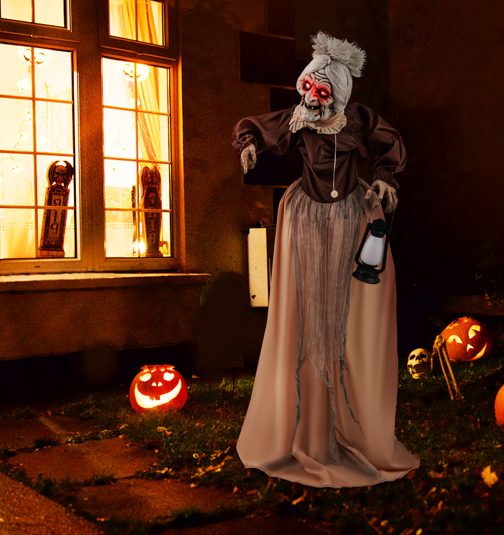 Life-size Halloween animatronic old lady hag prop with glowing red eyes, moving arms, and decorative lantern for spooky.