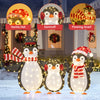 Three festive penguins with LED lights, wearing Santa hats and scarves, perfect for Christmas garden decorations.