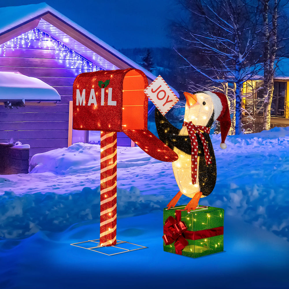 Lighted penguin decoration with mailbox and gift box, featuring 160 warm-white LED lights for festive outdoor display.