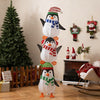 Stacked lighted penguin decoration with warm white lights, festive hats, and scarves for holiday cheer in any setting.