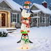 Stacked lighted penguins decoration with warm white lights and festive hats, perfect for holiday lawns or gardens.