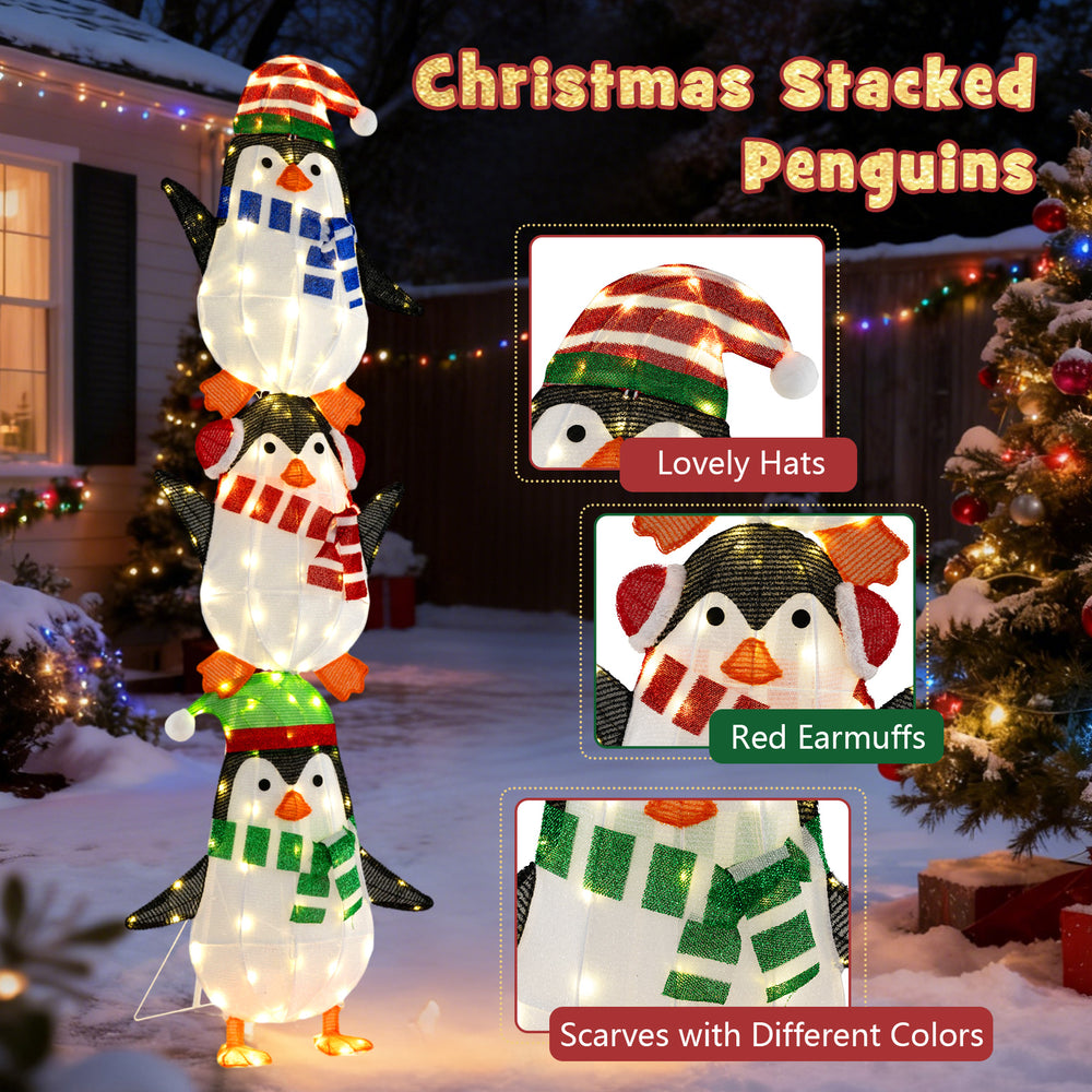 Stacked penguin decoration with warm white lights, cute hats, and scarves, perfect for Christmas lawn or porch display.