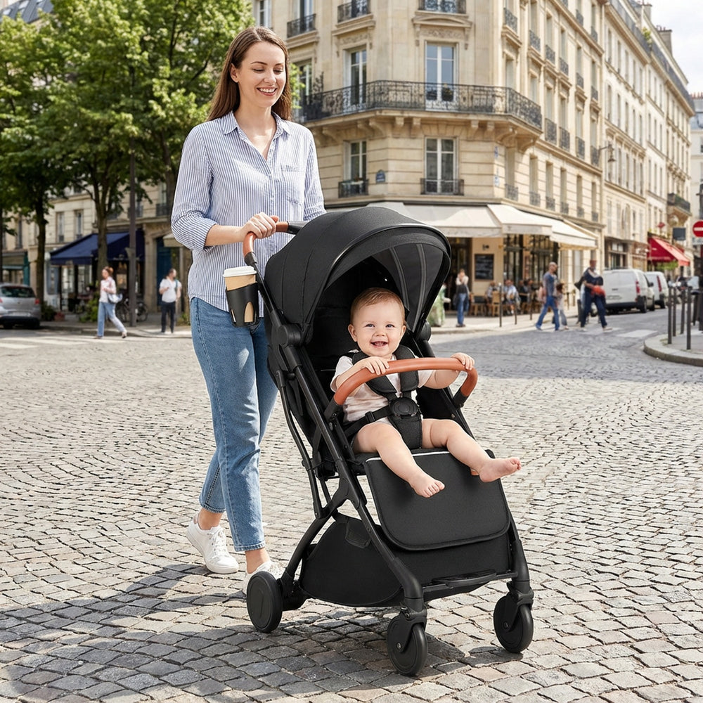 Lightweight black baby stroller with adjustable canopy and one-hand folding, perfect for travel and urban strolls.