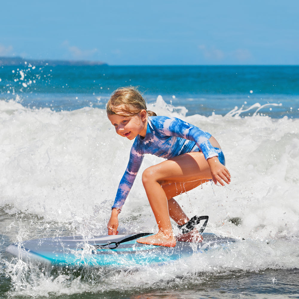 Lightweight boogie board with XPE deck and HDPE bottom, perfect for kids riding waves at the beach.