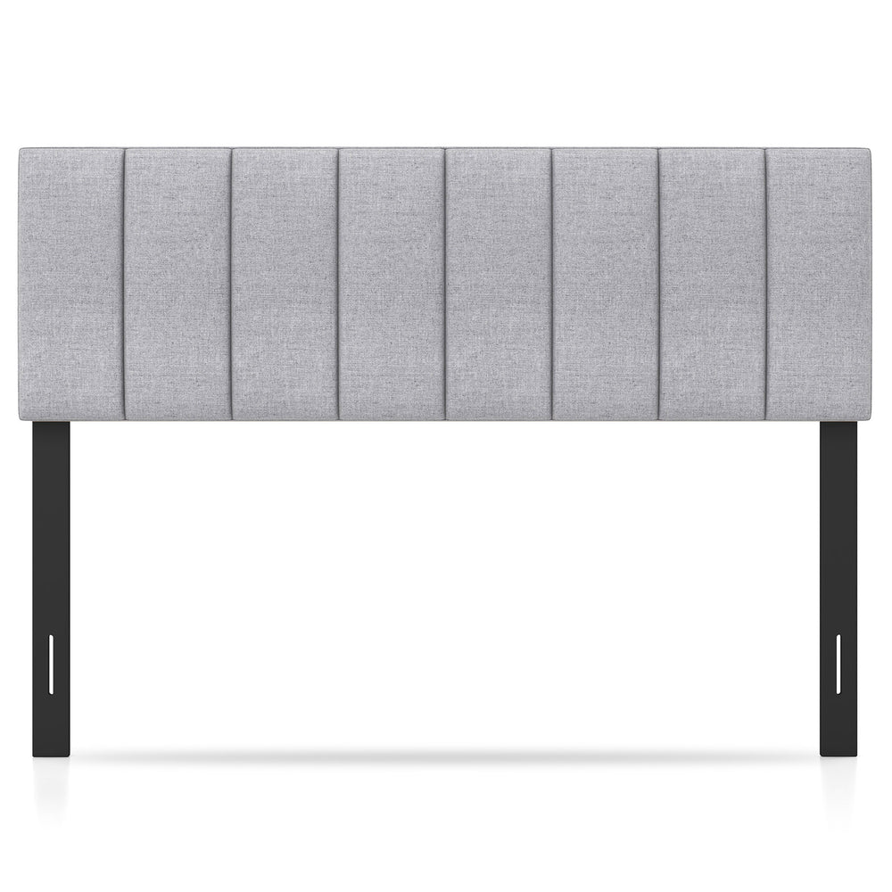 Gray linen upholstered headboard with vertical channel tufting and solid wood legs, adjustable for full or queen beds.