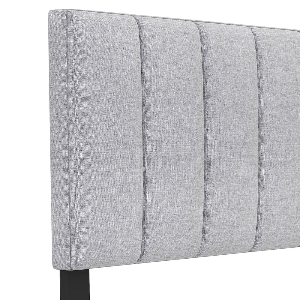 Gray linen upholstered headboard with vertical channel tufting, solid wood legs, and adjustable width for full or queen.