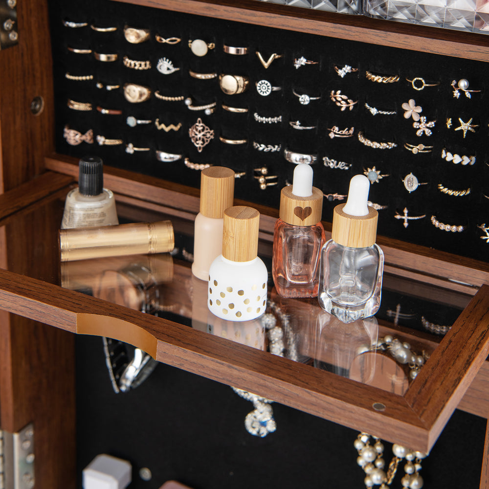 Jewelry cabinet with makeup shelf, featuring storage for bottles and accessories, in walnut finish with LED lights.