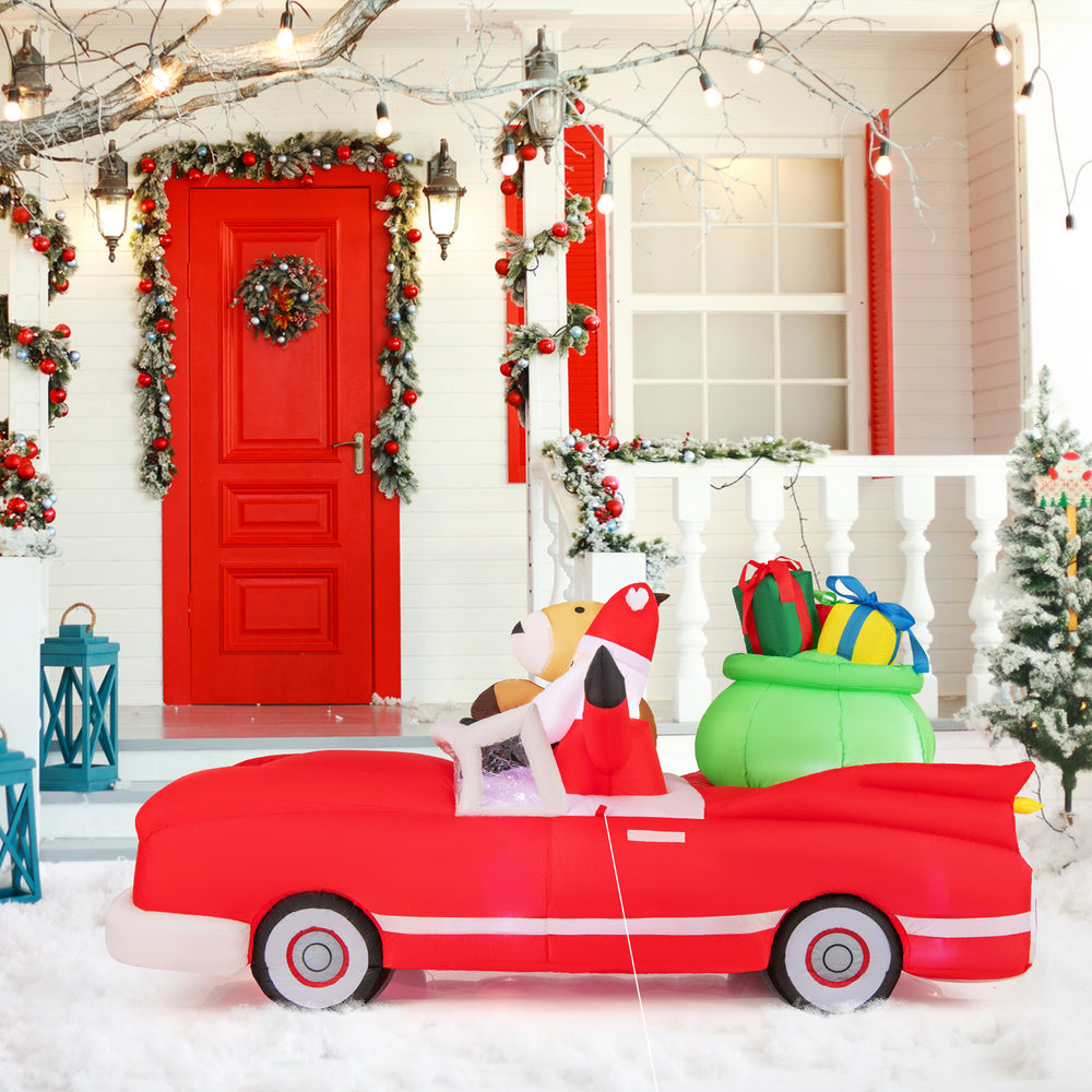 Side view of the inflatable red car with Santa and reindeer, featuring a gift bag and illuminated by 9 LED white lights.