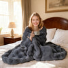 Cozy gray luxury fuzzy plush rabbit fur bubble blanket draped over a bed, perfect for warmth and comfort.