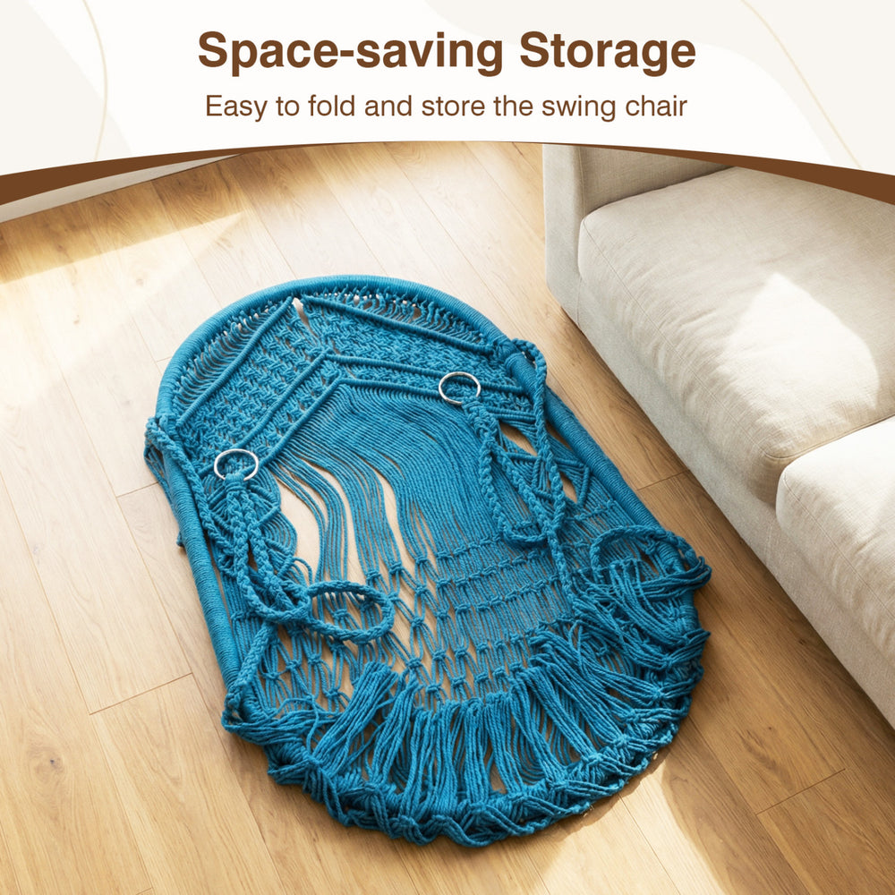 Navy macrame swing chair hammock with decorative fringes, folded for easy storage, suitable for indoor and outdoor use.