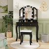 Black makeup vanity table set with lighted tri-fold mirror, cushioned stool, and spacious storage for beauty essentials.