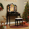 Black makeup vanity table set featuring a tri-folding lighted mirror, cushioned stool, and ample storage for beauty.