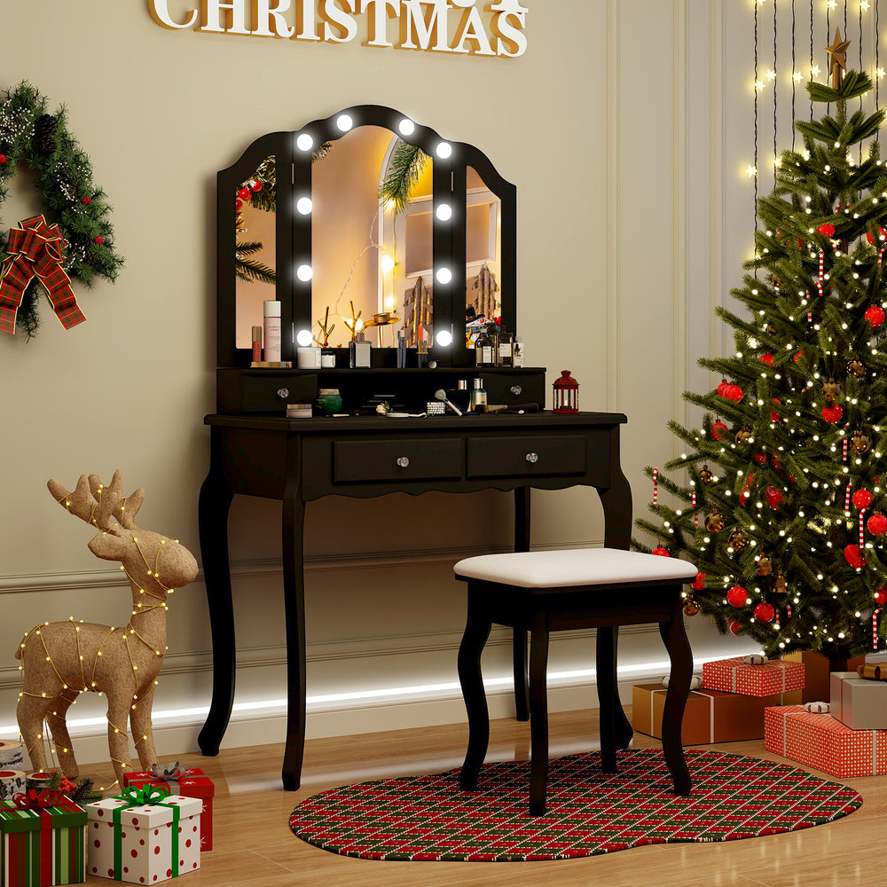Black makeup vanity table set featuring a tri-folding lighted mirror, cushioned stool, and ample storage for beauty.