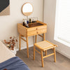 Bamboo makeup vanity table with movable mirror, two storage drawers, and tempered glass top for spacious organization.