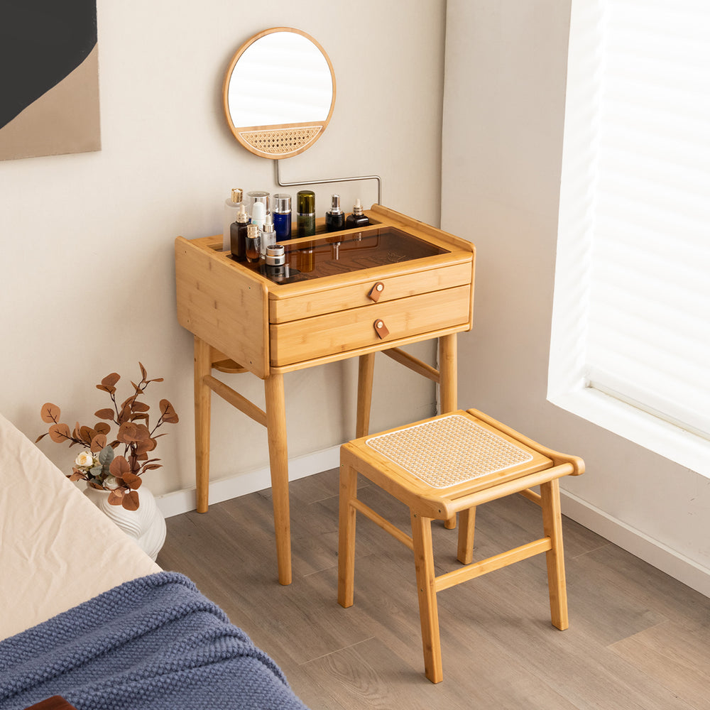 Bamboo makeup vanity table with movable mirror, two storage drawers, and tempered glass top for spacious organization.