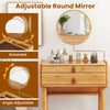 Adjustable round mirror on bamboo makeup vanity table with two storage drawers for convenient makeup application.