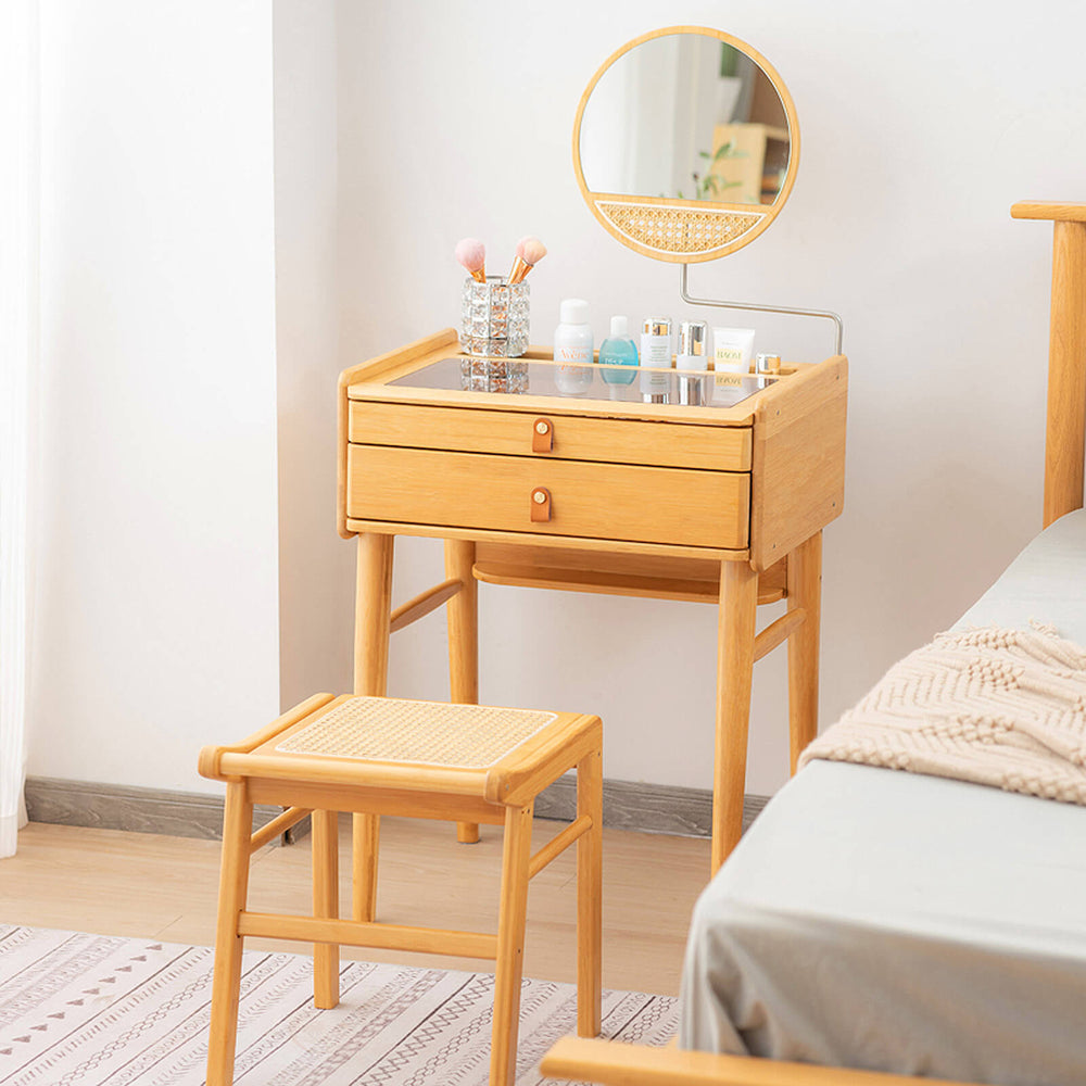 Bamboo makeup vanity table with rotating mirror, two drawers, and a stool, perfect for organized cosmetics in any room.