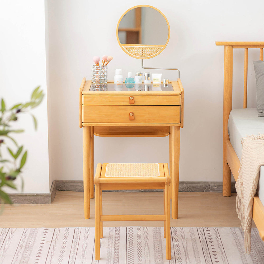 Bamboo makeup vanity table with smooth metal slides and deep storage alcove, paired with a versatile faux rattan stool.