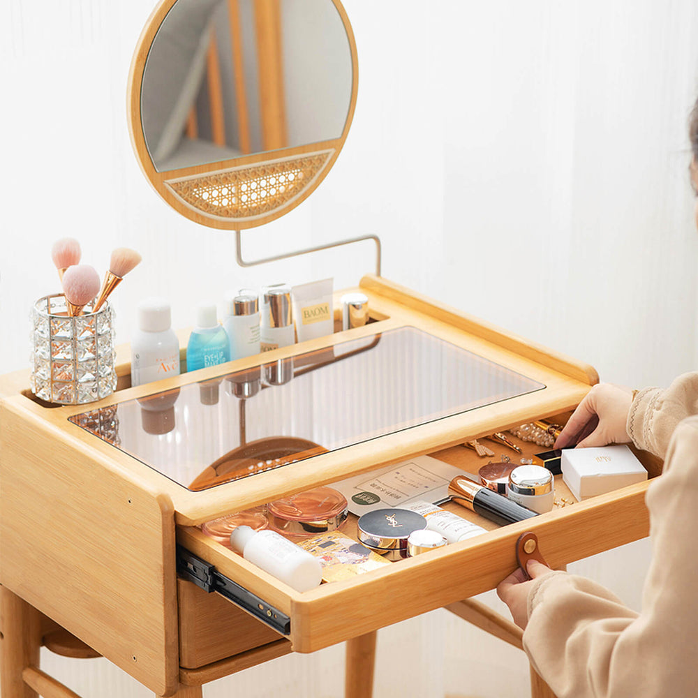 Bamboo makeup vanity table with rotating mirror, two drawers, and organized cosmetics for stylish storage and viewing.