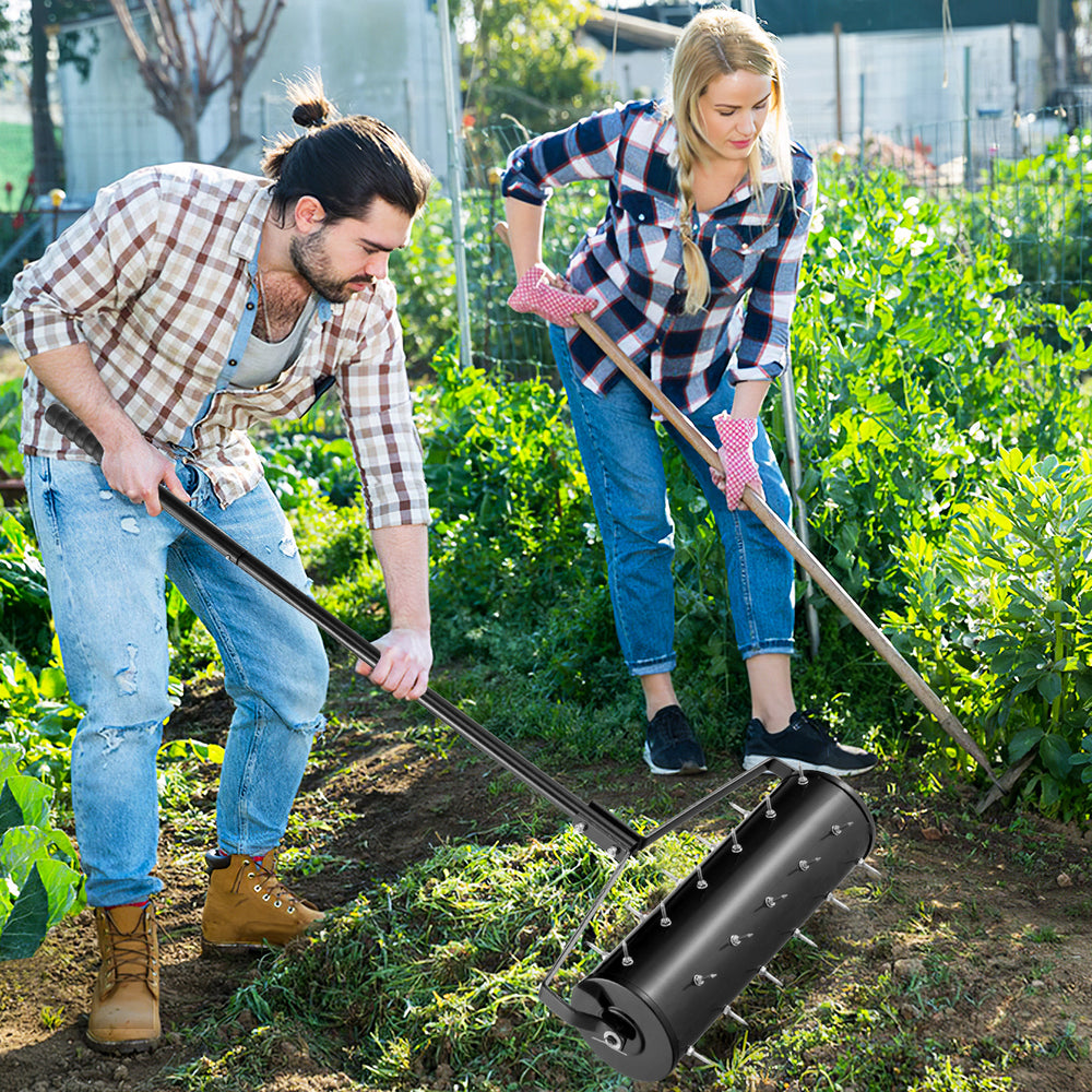 Manual lawn aerator with galvanized steel spikes, shown in use for effective soil loosening and plant growth.