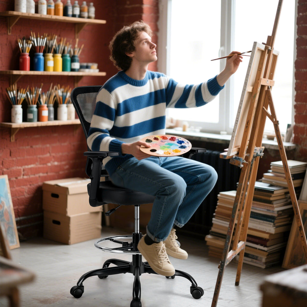 Mesh drafting chair with adjustable armrests and foot-ring, featuring ergonomic back support for comfortable painting.