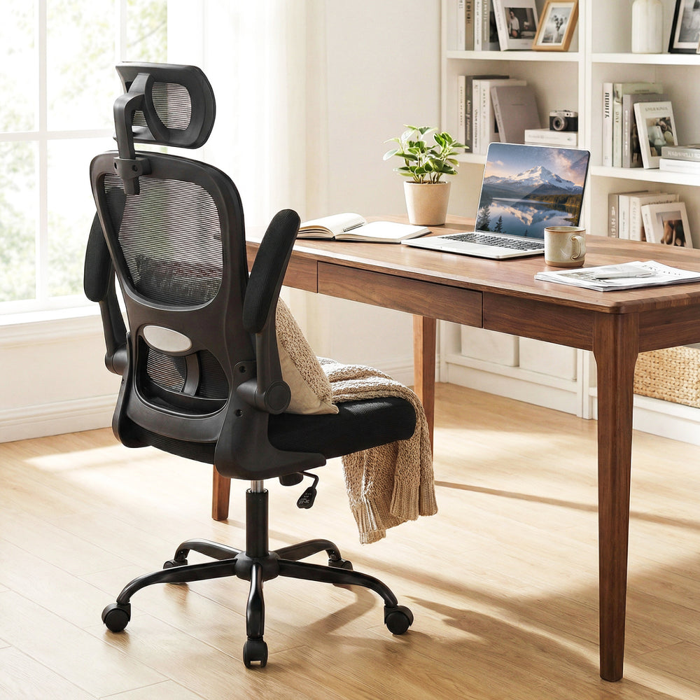 Black mesh office chair with adaptive lumbar support and flip-up armrests, designed for ergonomic comfort and.
