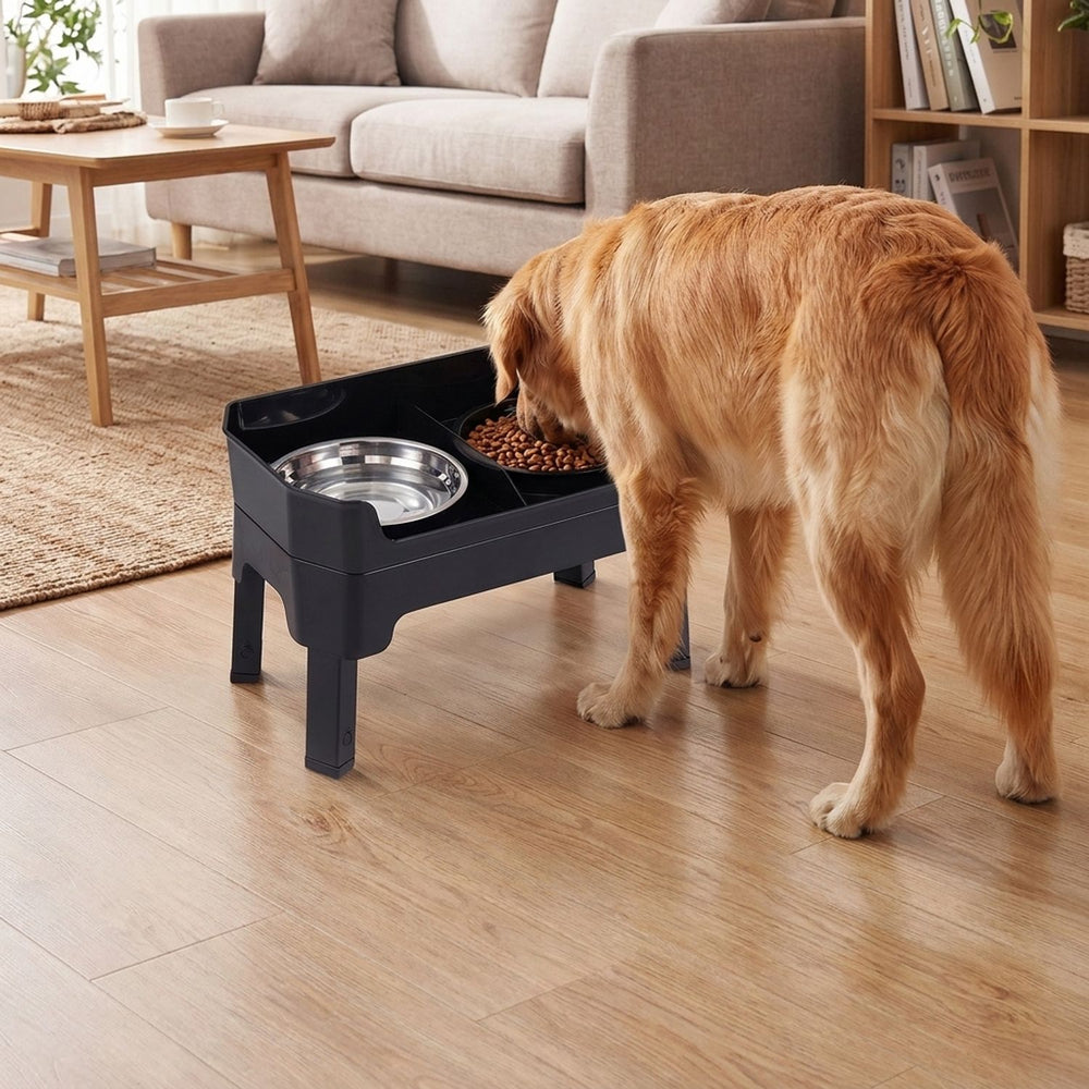 Black elevated dog bowls with adjustable heights and licking plate, shown beside a dog eating indoors.