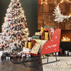 Red metal Christmas Santa sleigh basket with a charming design, perfect for holding ornaments and festive decorations.