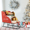 Red metal Christmas Santa sleigh basket filled with gifts, designed for festive storage and holiday decoration.