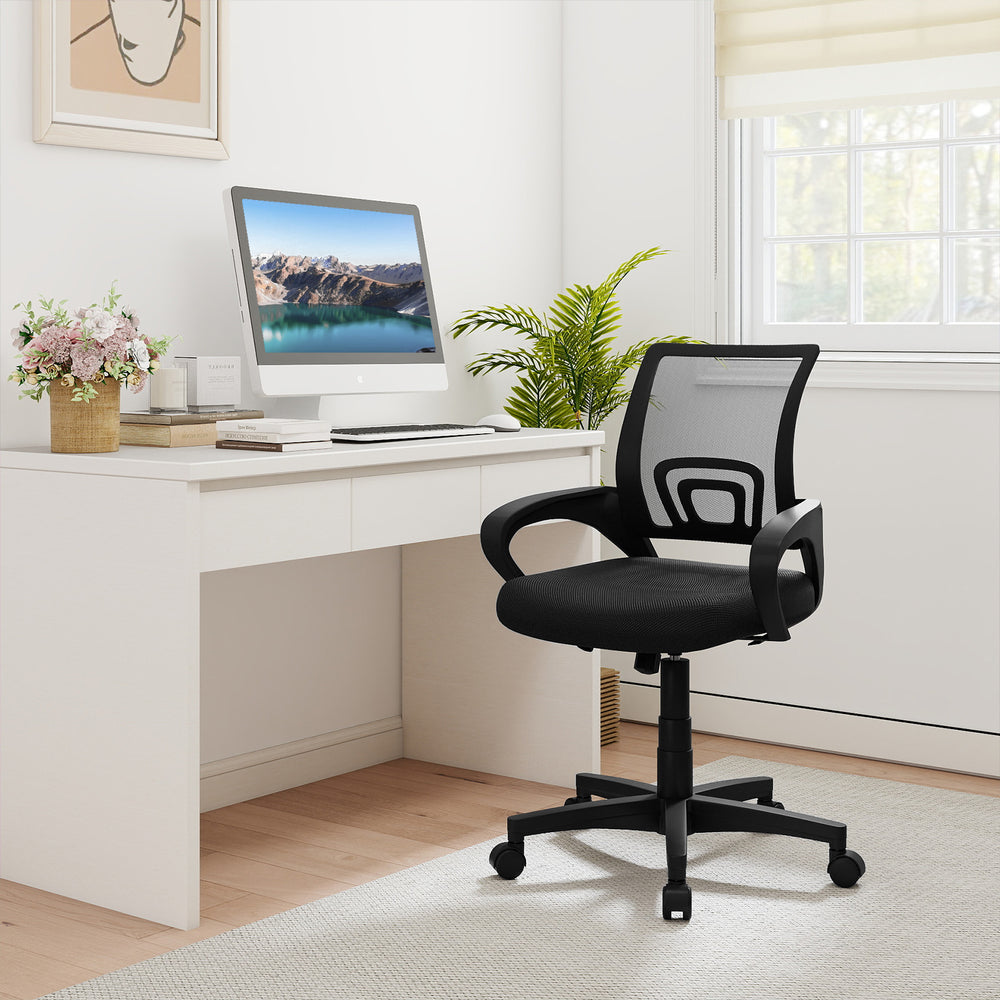 Mid-back ergonomic office chair in black with mesh fabric, lumbar support, and adjustable height for optimal comfort.