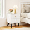 Mid Century Modern bedside table in white with golden knobs, featuring two drawers and tapered support legs for stylish.